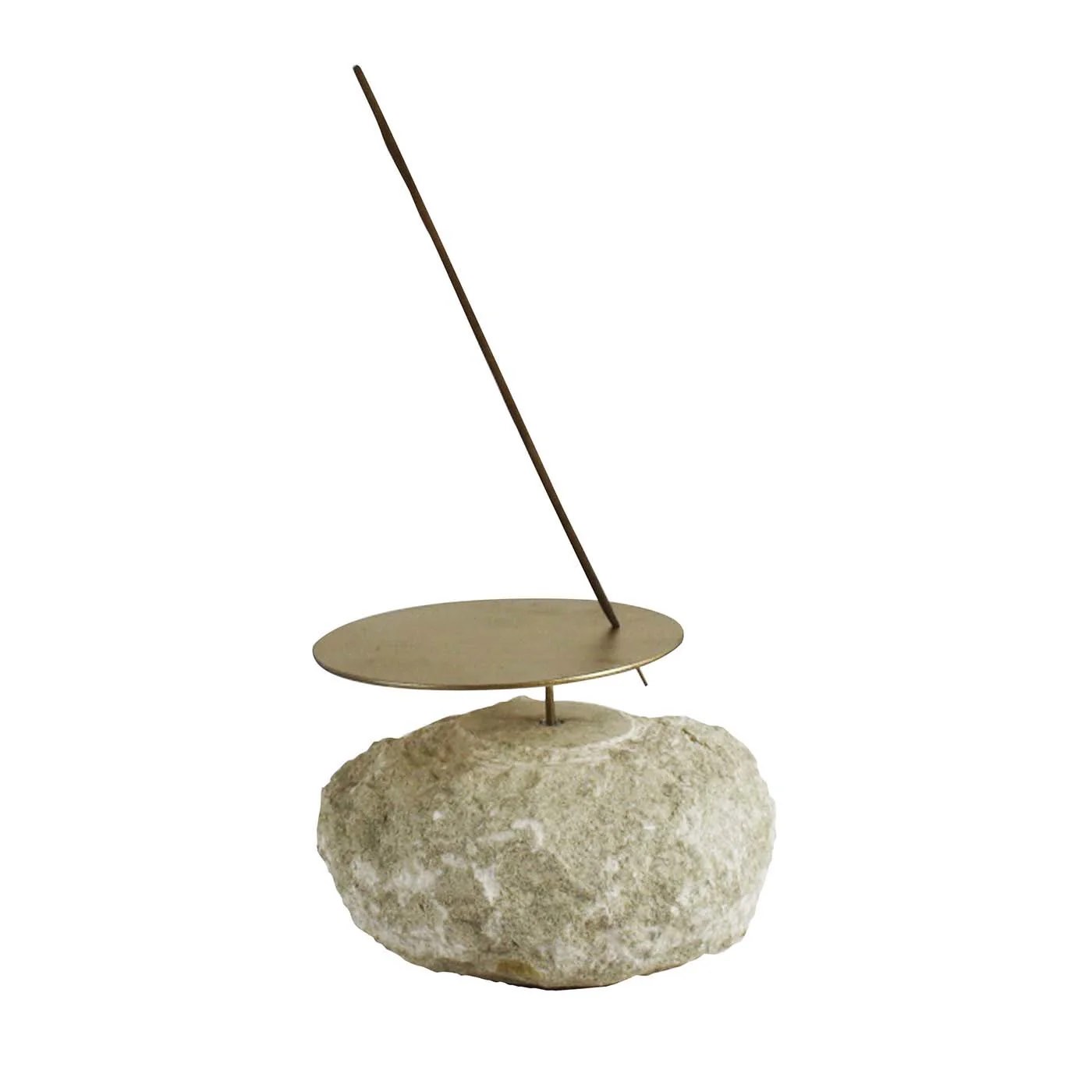 an incense stick on top of a rock